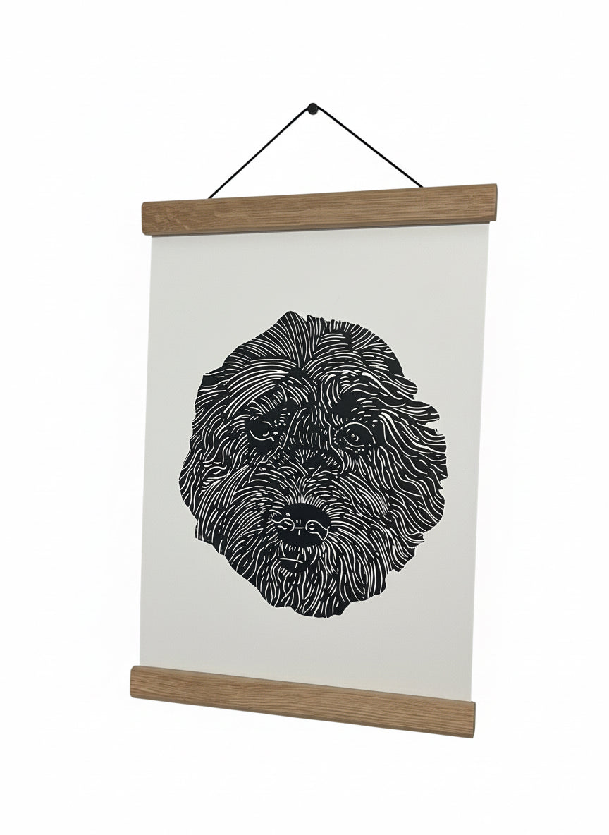 Black and white dog illustration on a white background with wooden frame hanging on a wall.