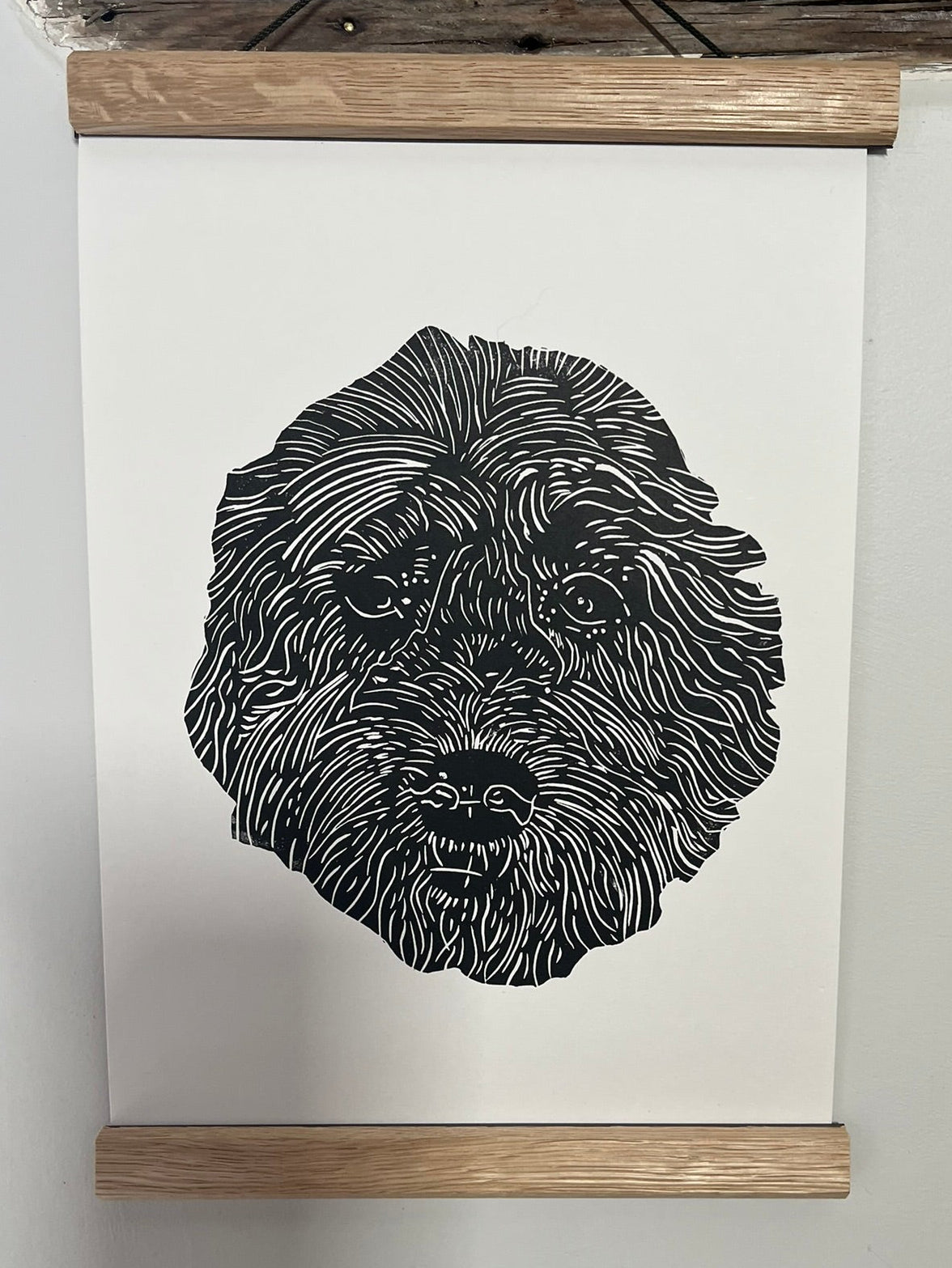 Black and white illustration of a dog's head on a white background with a wooden frame.
